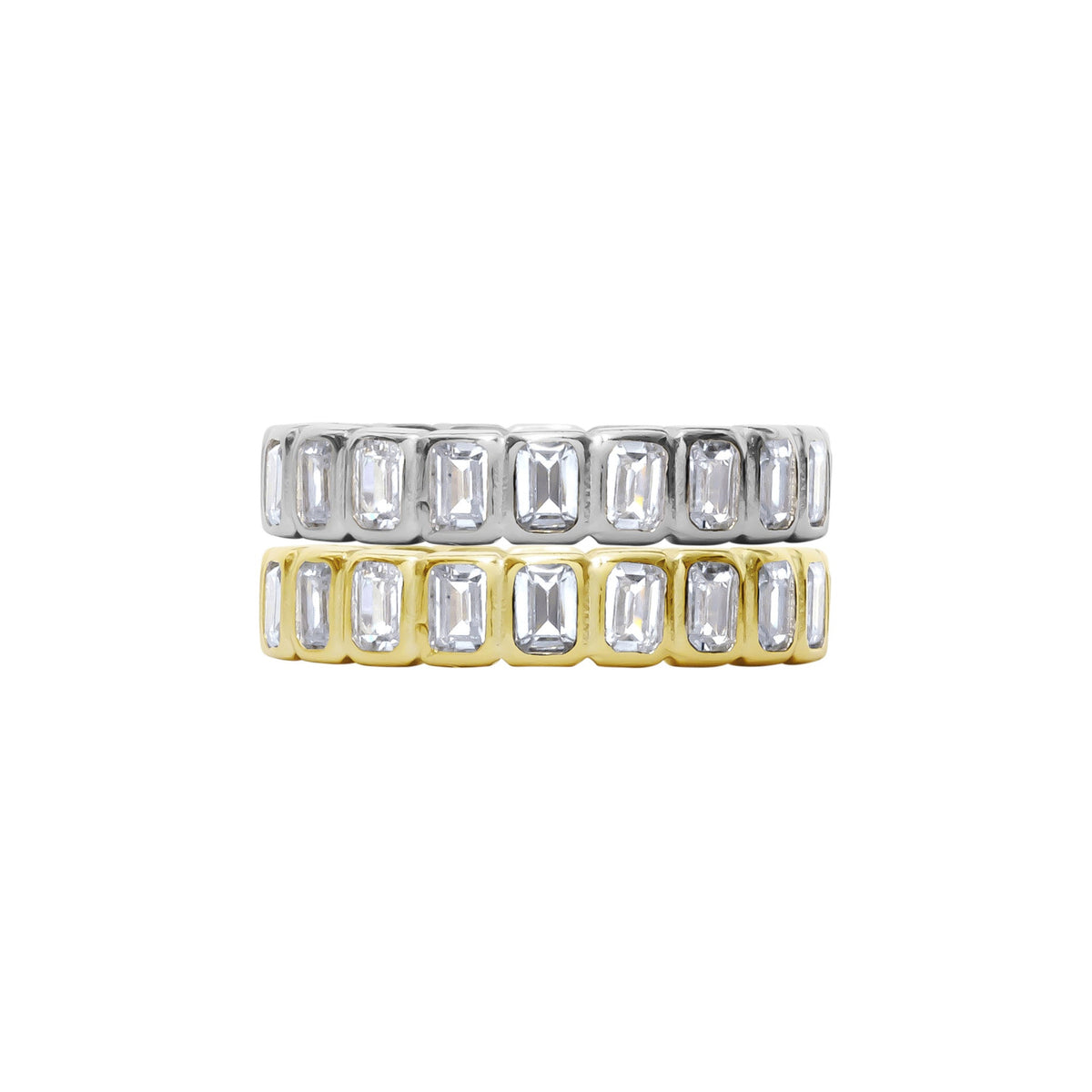 Two gold and silver rings with emerald-cut gemstones on a white background
